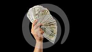 Fan of dollars in a male hand on a black background