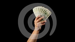 Fan of dollars in a male hand on a black background