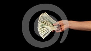 Fan of dollars in a male hand on a black background