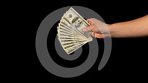 Fan of dollars in a male hand on a black background