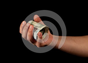 Fan of dollars in a male hand on a black background