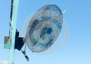 Fan with humidifier against blue sky