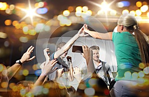 Fan making high five with singer at club concert