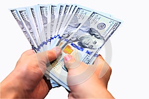 Fan of One Hundred Dollars notes in man hands, isolated on white background with clipping path
