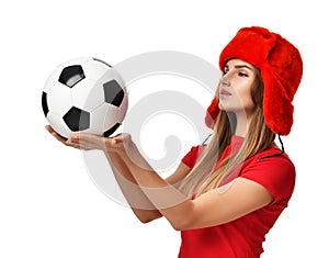 Fan sport woman player in red uniform and russian winter hat hold soccer ball celebrating