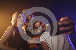 Fan taking picture with female performers