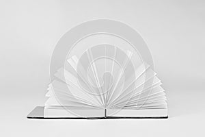 Fan unfold open small notepad with blank light pages. Notebook. White back