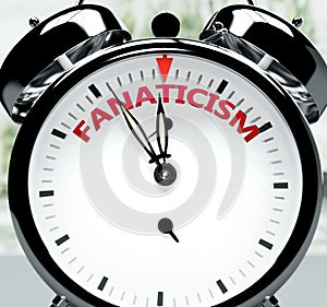 Fanaticism soon, almost there, in short time - a clock symbolizes a reminder that Fanaticism is near, will happen and finish