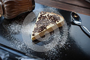 Fancy cheesecake in cafe with chocolate drops and spoon