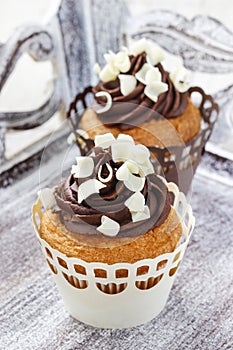 Fancy chocolate cupcakes on wooden table