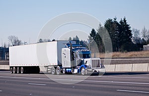 Fancy classic chromy bright blue shiny semi truck big rig