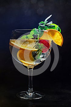 Fancy cocktail with fresh fruit. Gin and tonic drink with ice at a party