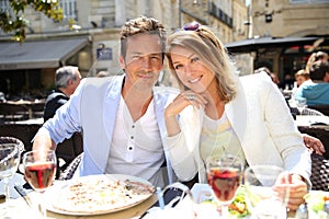 Fancy couple in a fancy restaurant eating lunch and drinking wine