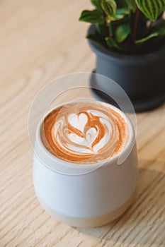 Fancy cup of coffee or hot chocolate in modern hipster cafe.