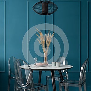 Fancy dining room with blue wall with molding