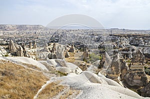 Fancy geological mountain formations with dovecotes of the Pigeon valley in Goreme, Cappadocia, Turkey