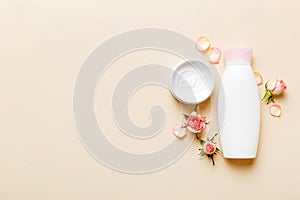 Fancy healthcare bottles for cream with rose flower. Natural oranic spa cosmetics concept. Mockup, template, Top view