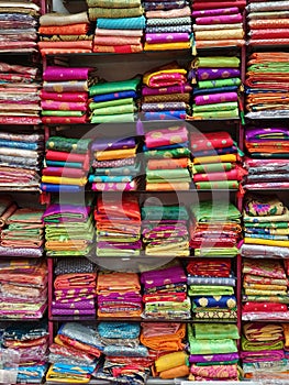 Fancy Indian sarees, Neatly stacked colorful silk saris in racks in a textile shop. Incredible India