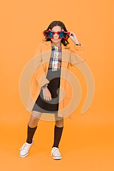 Fancy look. Little girl with autumn look. Party look of fashion schoolchild. Small child look geeky in star-shaped