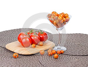 Fancy orange cherry tomatoes and red tomatoes on vine.