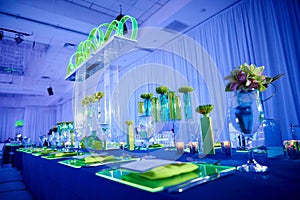 Fancy orchid flower arrangement set up for a wedding party in a ballroom with lucite decoration photo