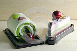 Fancy soap in cake form with cherry on the top on wooden board b