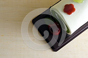 Fancy soap in rolled cake form with cherry on the top with blank