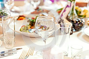 Fancy table set for dinner with napkin glasses in restaurant, luxury interior background. Wedding elegant banquet