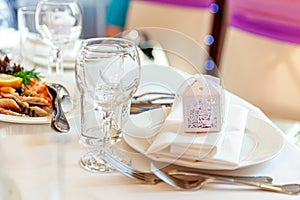 Fancy table set for dinner with napkin glasses in restaurant, luxury interior background. Wedding elegant banquet