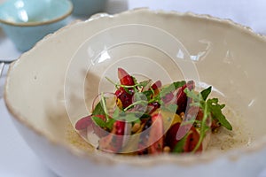 Fancy tomato salad in white bowl