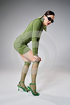 Fancy woman in green mini dress