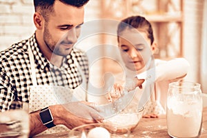 Fanher with Doughter Pour Flour in Bowl Eggs.