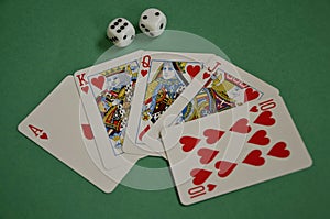 Fanned Out Red Hearts Poker Royal Flush and Dice on Green Baize