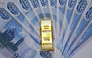 fanned out Russian rubles and a gold ingot of the highest standard