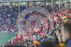 Fans in the stands at the stadium. Supporting your favorite baseball team in Tokyo. Blurred