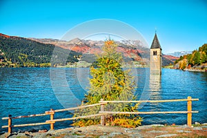 Fantasic autumn view of submerged bell tower in lake Resia