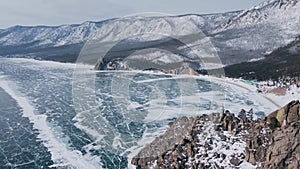 Fantastic aerial view over snowy mountain range. Beautiful landscape of frozen bay and white peaks. Drone shot of