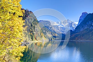 Fantastic autumn sunshine lights on mountain lake Gosausee