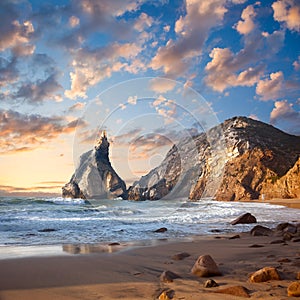 Fantastic big rocks and stones on the ocean beach at sundown