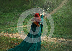 Fantastic character, bright photo, the best woman shooter bravely and courageously goes hunting, red-haired girl is