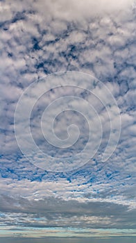 Fantastic clouds against blue sky, panorama