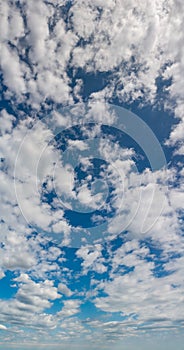 Fantastic clouds against blue sky, panorama