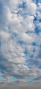 Fantastic clouds at sunrise, vertical panorama