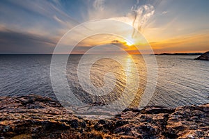 Fantastic, cloudy sunset over the sea seen from a cliff