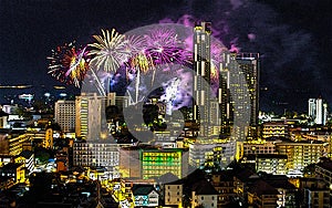 A fantastic and colorful fireworks display over the night sky of the city during a festival