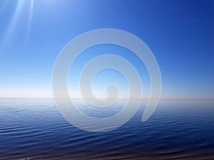 Fantastic colorful sea view on a cloudless Sunny day. Variety of blue shades. Very beautiful blue sky and reflection from the