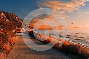 Fantastic Colorful Sunset over the sea. Wonderful coastline under sunlit with dramatic Picturesque sky glowing warm sunlight.