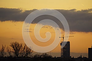 Fantastic Dramatic bright Sunny sunset over the industrial city. Silhouette of City. Selective Focus. Beautiful Natural