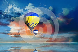 Fantastic dreams. Hot air balloons in blue sky with clouds over sea