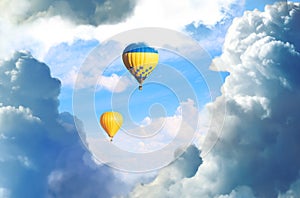 Fantastic dreams. Hot air balloons in blue sky with fluffy clouds